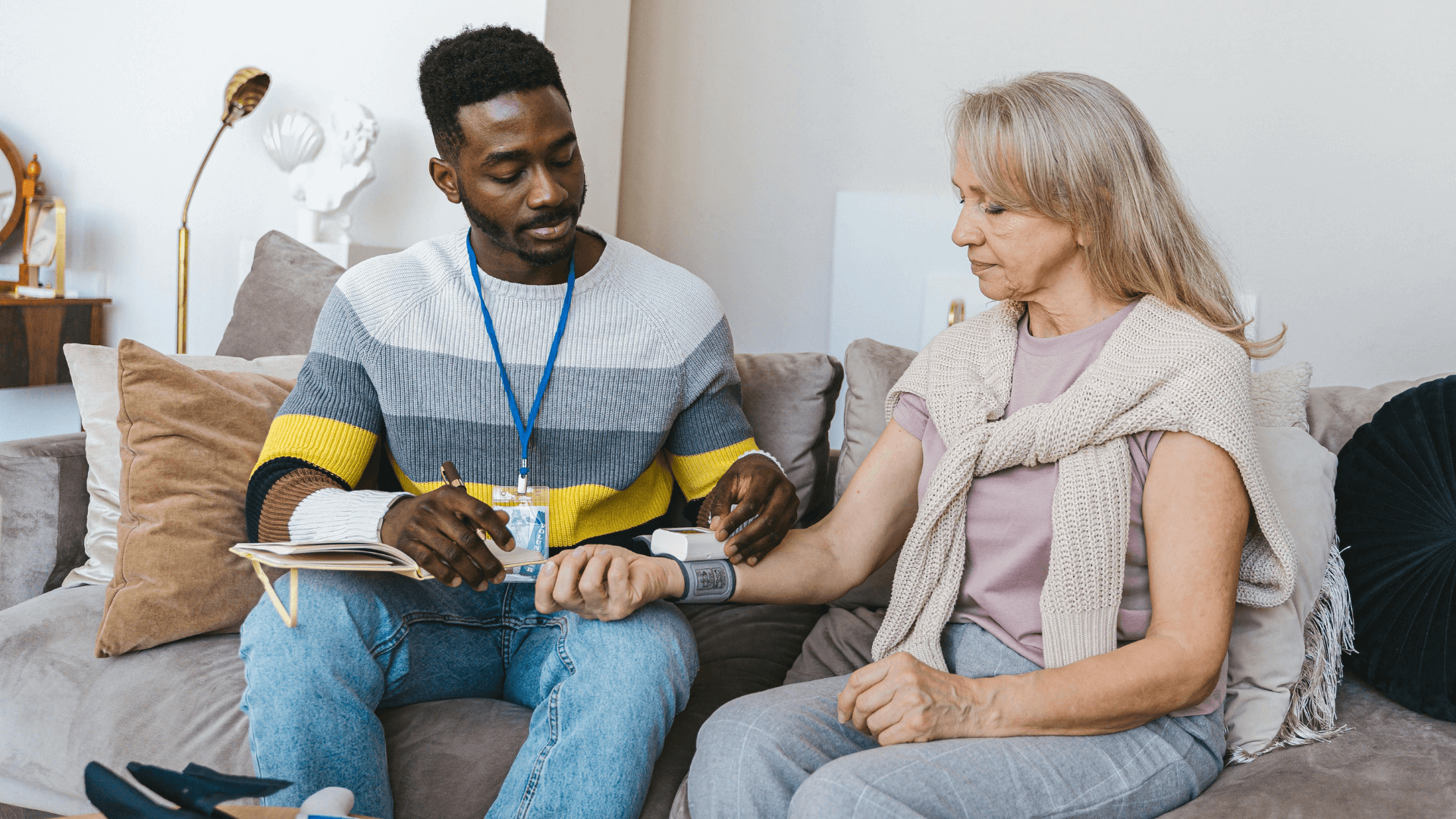 A man checking Blood Pressure of an old age woman