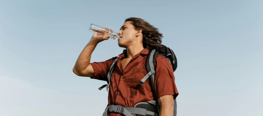 A guy drinking water during Trekking